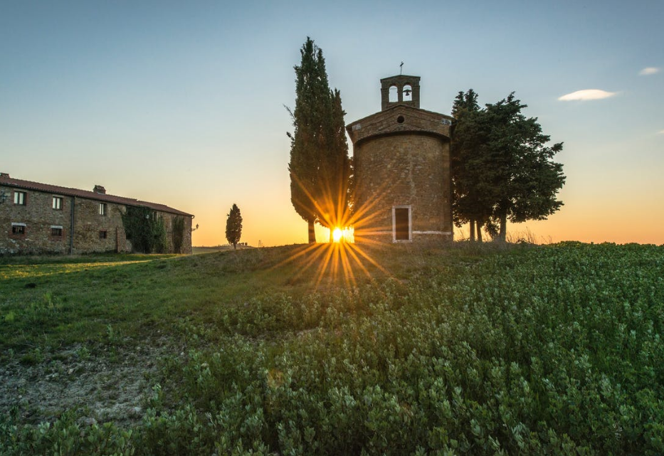 sun behind tower